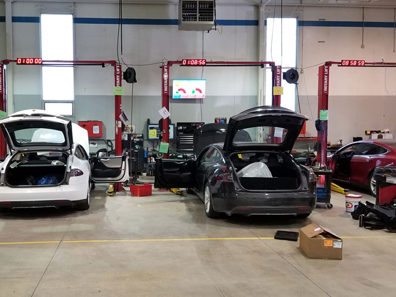 3 cars being serviced at an auto center under Hernick Rotary lifts
