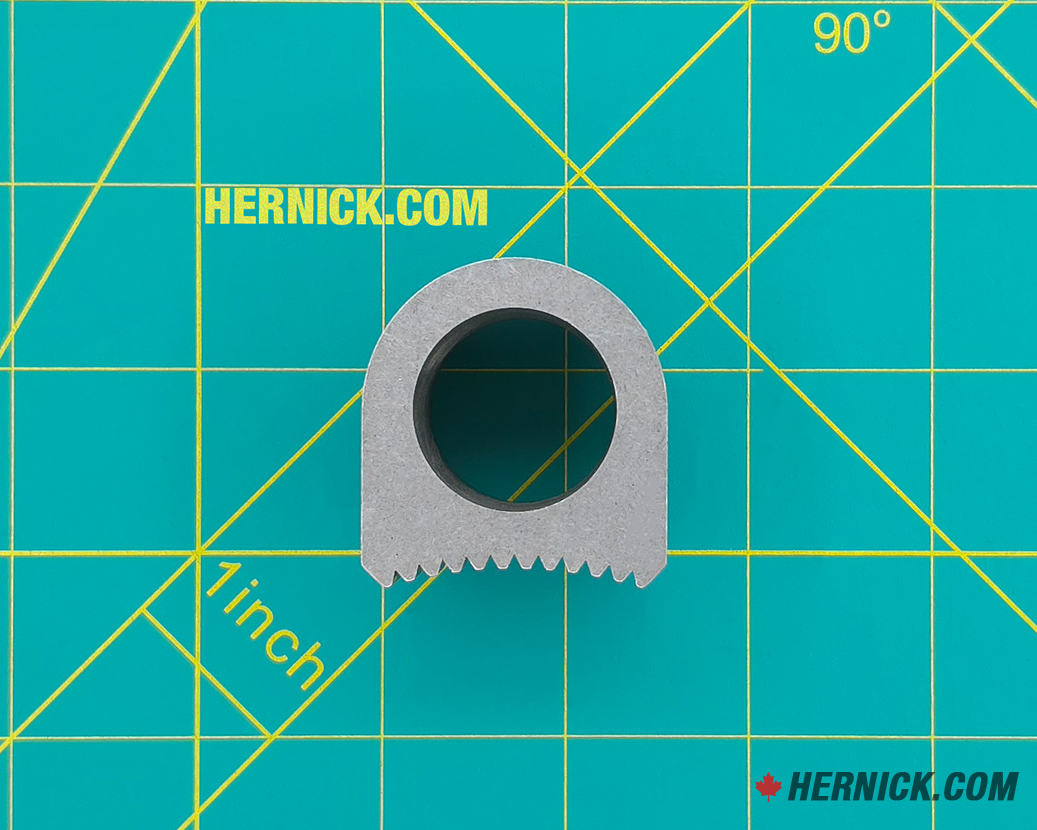 Small heavy-duty steel arm restraint engagement gear and pawl with toothed engagement surfaces on a green background with yellow grid markings.