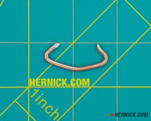 Small steel Rotary FJ671-6 hog ring retaining clip designed to secure an applicable pin or component in position on compatible Rotary lift assemblies on a green background with yellow grid marks.