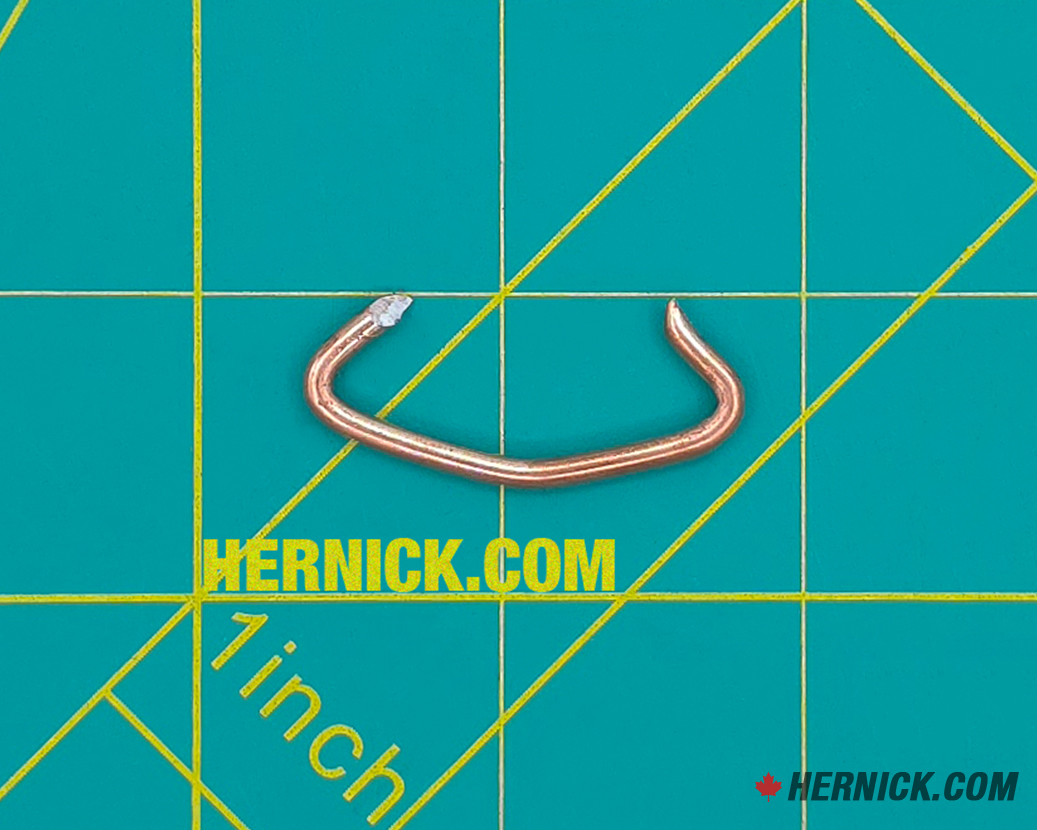 Small steel Rotary FJ671-6 hog ring retaining clip designed to secure an applicable pin or component in position on compatible Rotary lift assemblies on a green background with yellow grid marks.