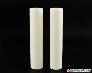 Two white coalescent filters standing vertically on a black back ground.