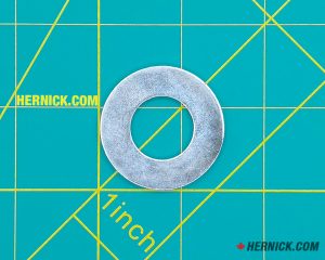 Round steel bushing washer on a green background with yellow grid markings.