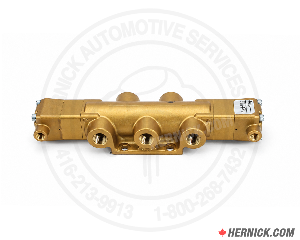 A brass coloured OEM valve with 3 ports facing forward casting a shadow on a white background