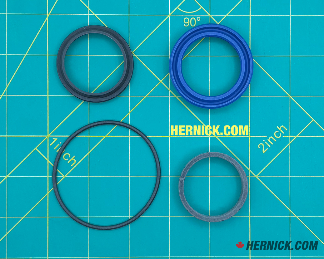 Hydraulic cylinder seal kit on a green background with yellow grid marks