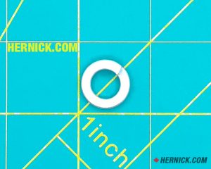 metal 10mm locking washer on a green background with yellow grid markings.