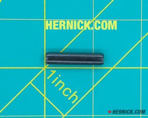 Small slotted cylindrical spring roll pin made from hardened steel on a green background with yellow grid markings.