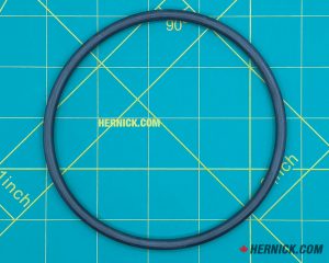 Black rubber O-ring on a green background with yellow grid markings.
