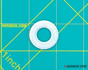 Wheeltronic 6-0248 steel flat washer on a green background with yellow grid markings.